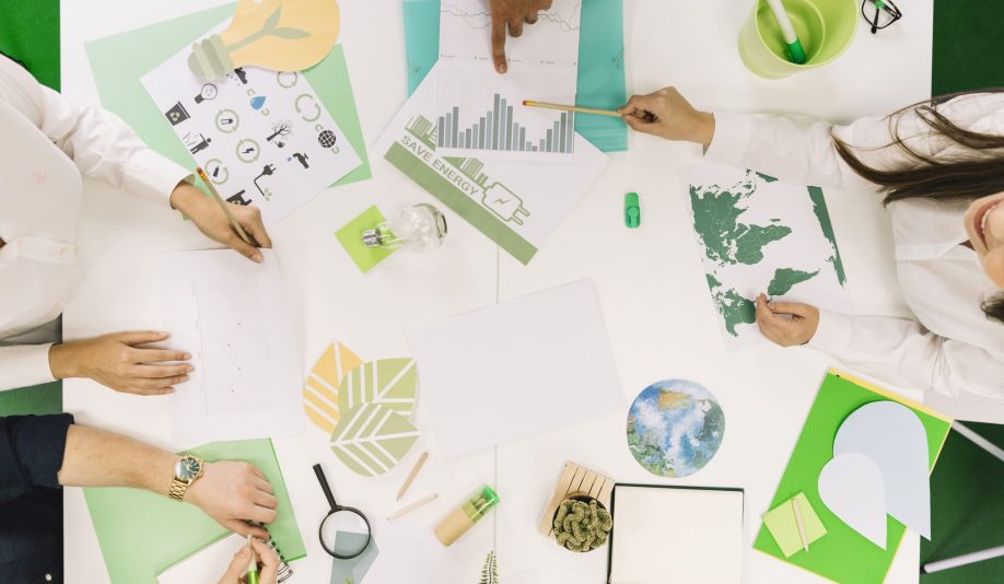businesspeople-working-graph-with-various-natural-resources-icon-desk